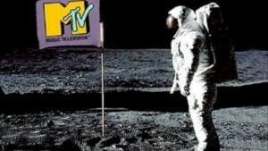 astronaut looking at a banner with an music television emblem on it