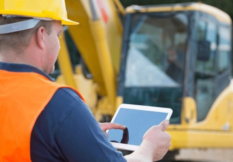 a construction worker touching the screen of a tablet, gis database